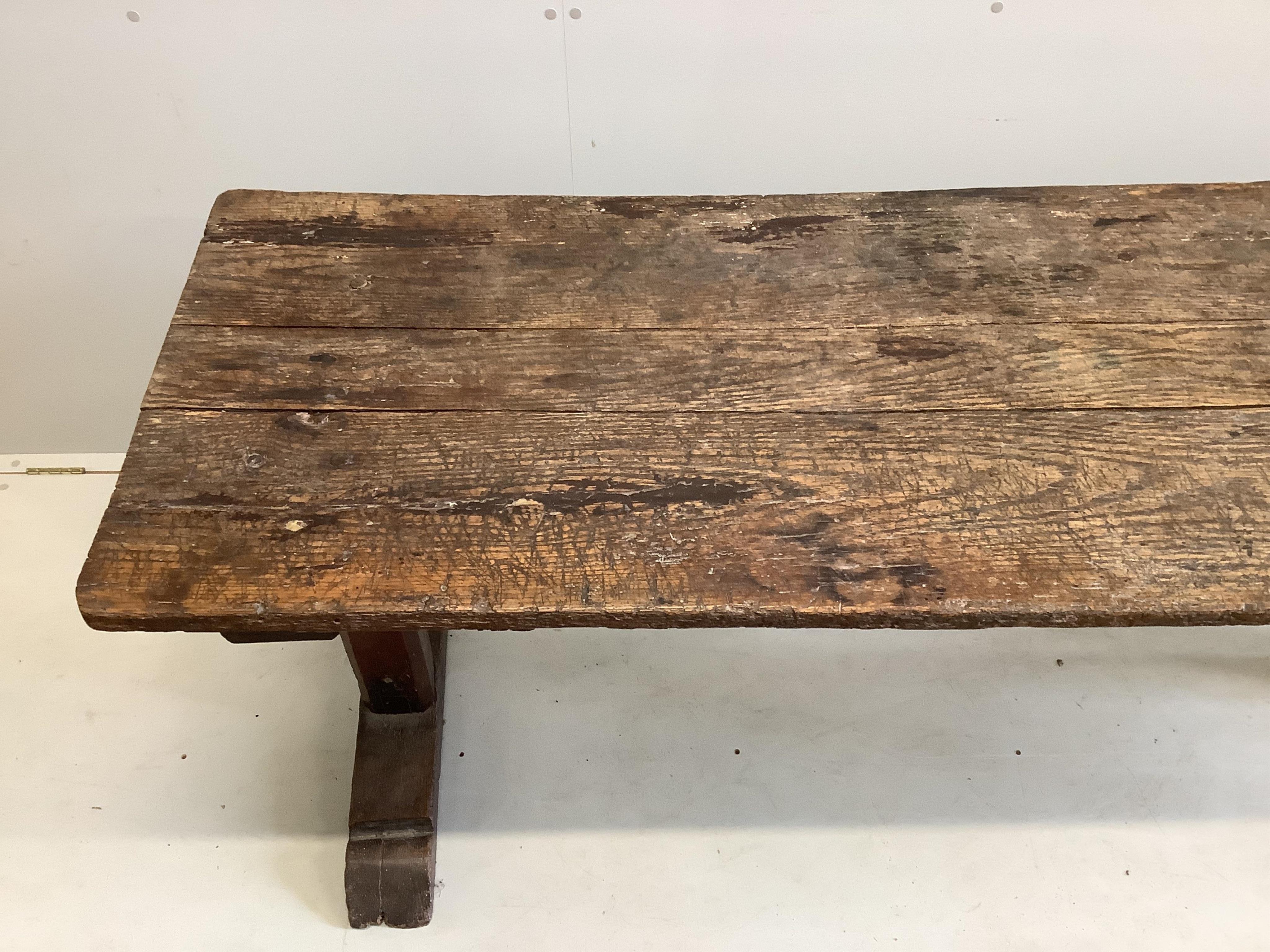 A 17th century elm topped oak refectory table, width 199cm, depth 69cm, height 75cm. Condition - poor-fair